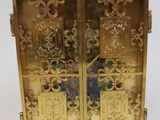 an image of a golden clock with a cross on the front