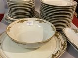 a lot of plates and bowls sitting on a table