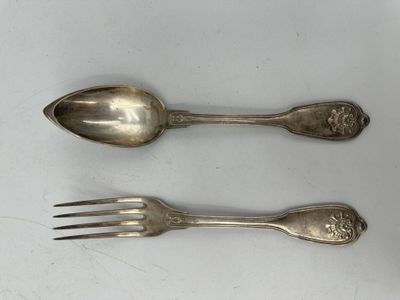 two spoons and a fork sitting on a table