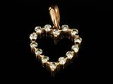 a gold heart shaped pendant with clear crystals on a black background