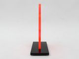 a red pole with a black base on a white surface