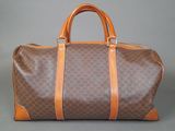 a brown and orange duffel bag sitting on top of a table