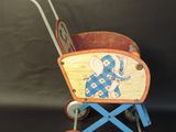 a wooden toy bike with wheels attached to a wall