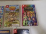 several nintendo wii games are on a white table