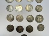 a bunch of coins sitting on top of a table next to each other