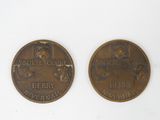 two coins that are sitting side by side on a white surface