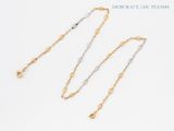 three different types of gold and silver chain necklaces on a white background