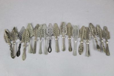 a lot of silver spoons and spoons on a white surface