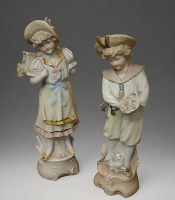 pair of porcelain figurines of a boy and a girl