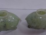 two green vases sitting next to each other on a table