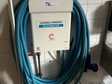 a blue hose attached to a wall in a public bathroom