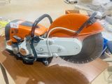 an orange and white machine sitting on top of a wooden table