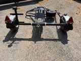 a trailer with a motorbike attached to it in a parking lot