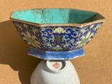 a blue and white bowl sitting on top of a white vase