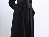an image of a mannequin wearing a black dress and coat