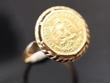 Gros plan sur une bague ornée d'une pièce d'or
