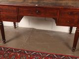 a wooden desk with a mirror on top of it