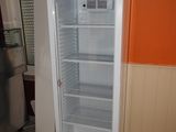 an empty refrigerator in the corner of a kitchen