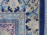 an image of a rug with a blue border on the ground