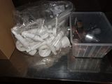 a plastic container filled with toilet paper next to a plastic container filled with toilet paper