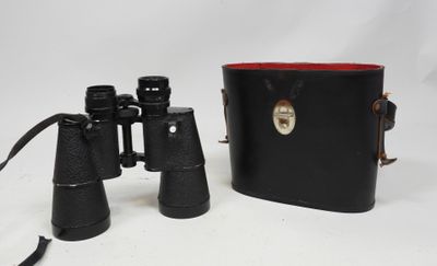 an image of a pair of binoculars sitting next to a leather case