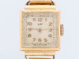an image of a gold wrist watch with roman numerals