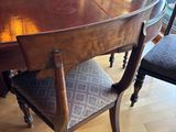 a wooden table with chairs around it in a room