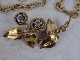 gold tone rose necklace with crystal stones and gold chain