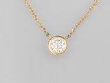 a single diamond pendant on a gold chain