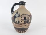 a vase with a picture of a house on it