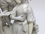 a statue of a woman and a child on a rock