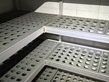 many shelves with holes on them in a store