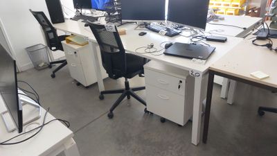un bureau sur lequel sont posés deux ordinateurs et un ordinateur portable