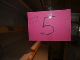 a pink sign with the number 5 on it in a store