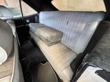 a dirty seat in the back of a car
