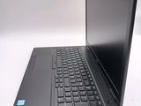 a laptop with a black keyboard on a white surface