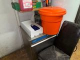 a chair that has a bucket on top of it