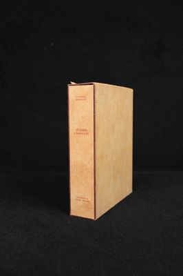 a brown book sitting on top of a black surface