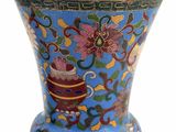a blue vase with a floral design on it