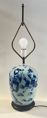 a blue and white vase with a light on it