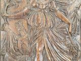 an image of a wooden plaque with a woman in a dress