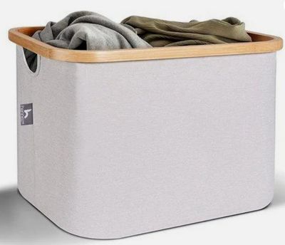a close up of a white laundry basket with clothes in it