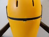 a yellow helmet with a black zipper on top of it