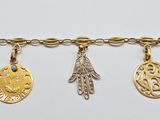 a close up of a gold bracelet with charms on it