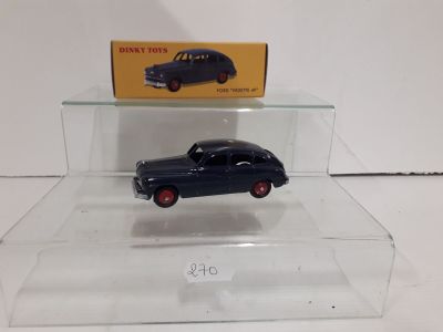 a toy car in a clear display case on a table