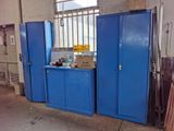 a blue cabinet in the middle of a room with blue doors