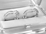 two silver rings in a clear box on a table