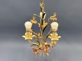 a gold chandelier with flowers and leaves on it