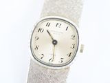 a silver wrist watch with roman numerals on it