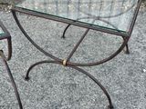 a glass table with a metal base and a glass top